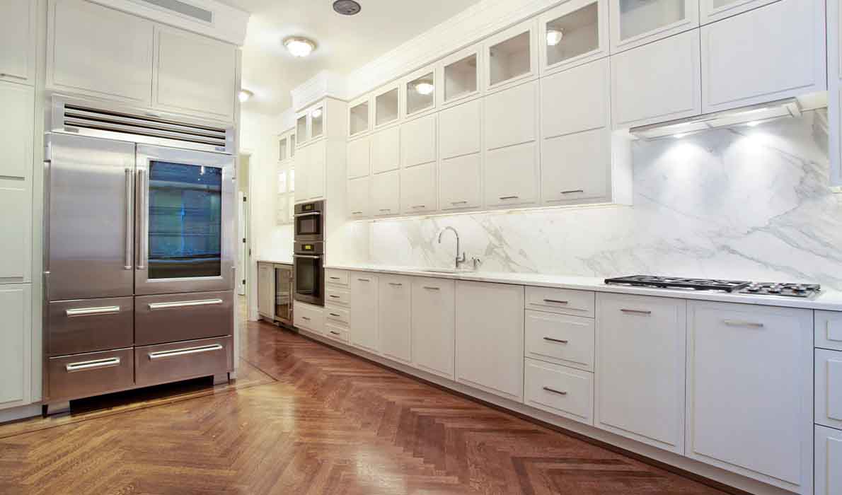 Luxury modern kitchen renovation at 390 West End Ave apartments in NYC by Universal Management & Contracting Corp, featuring custom cabinetry, marble backsplash, and stainless steel appliances.