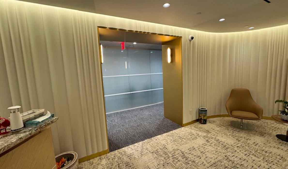 Modern office interior renovation with custom wall panels and lighting by Universal Management and Contracting, a leading NYC commercial construction company.