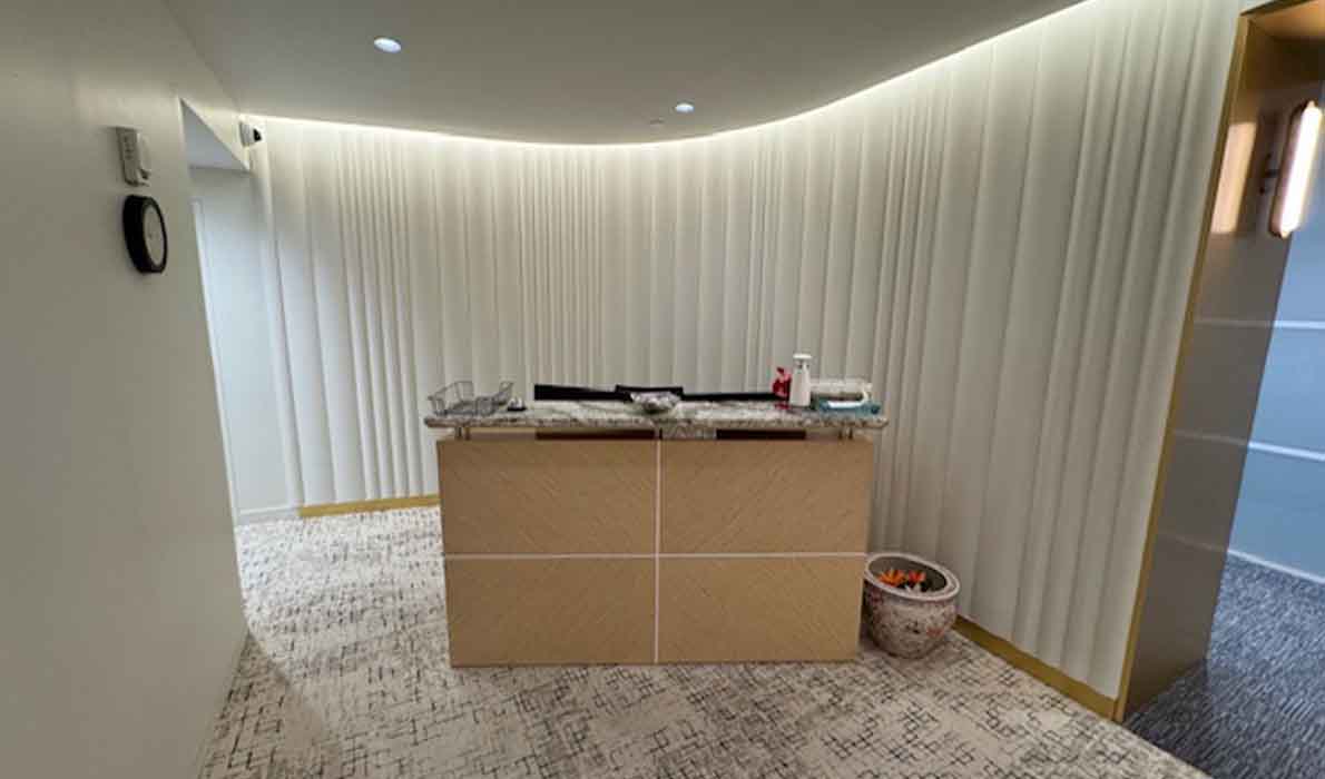Elegant office reception area renovation featuring custom millwork and modern lighting by Universal Management and Contracting, NYC commercial construction experts.